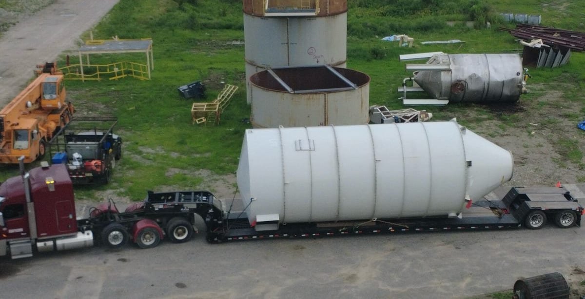Industrial silo secured on a lowboy trailer