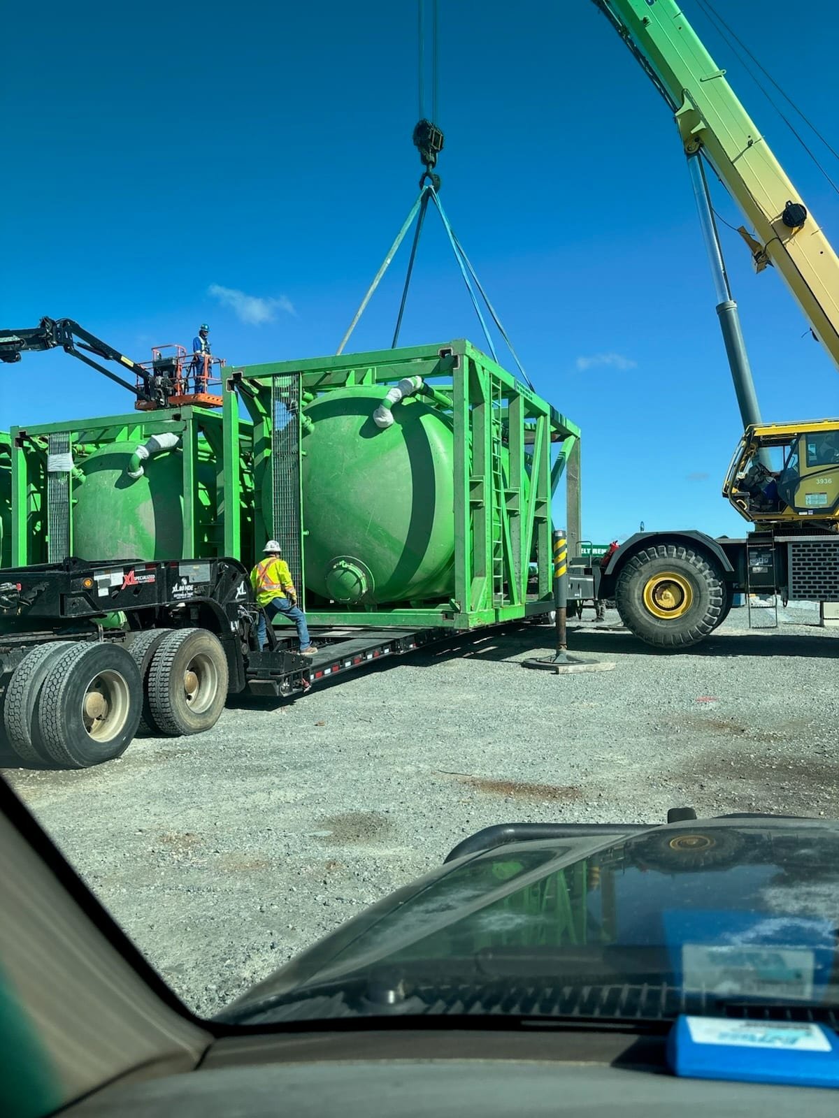 Crane lifting a pressure vessel onto a trailer