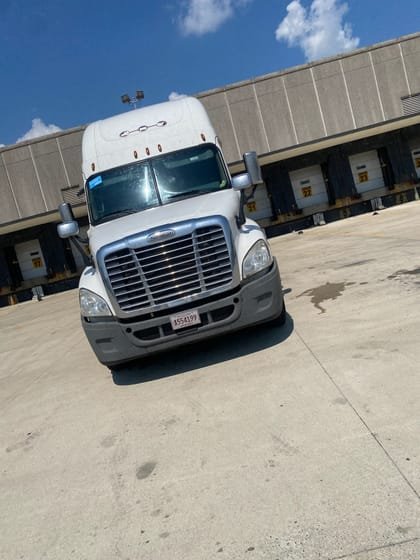 Freightliner day cab at a loading dock