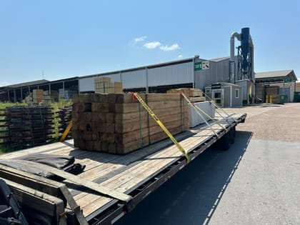 Bundled lumber loaded across a flatbed