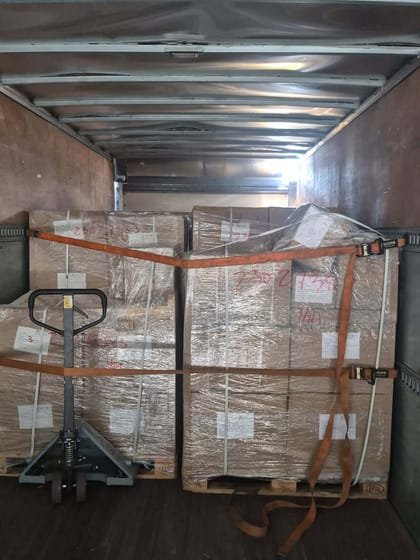 Wrapped pallets and a pallet jack in the trailer