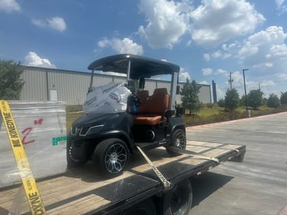 Utility vehicle strapped to the deck