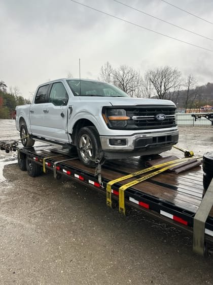Pickup loaded and strapped on a deck